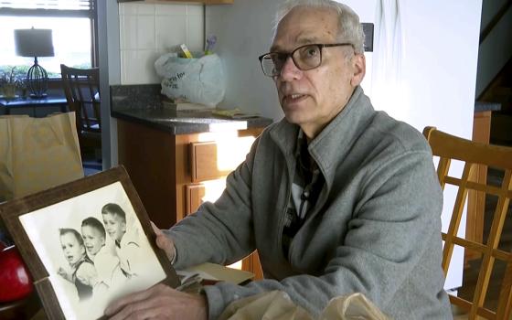 John Prevost, brother of Pope Leo XIV, holds a portrait of the three Prevost brothers from 1958 — Robert (now Leo), 3, left, John, 4, and Louis, 7 — at his home Thursday, May 8, 2025, in New Lenox, Illinois. (AP photo/Obed Lamy)