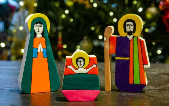 La Palma folk art nativity with Jesus, Mary and Joseph, against a backdrop of Christmas lights (Unsplash/Mick Haupt)