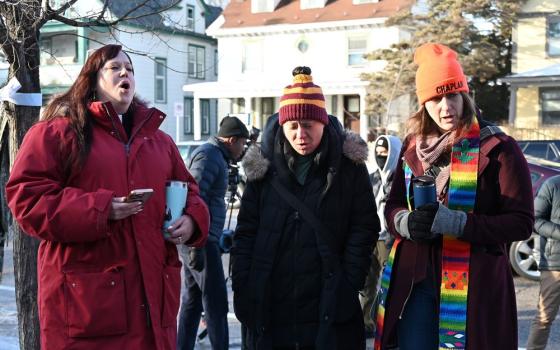 Clergy members sing the hymn "We Rise" at a memorial honoring Renee Good, who was fatally shot Jan. 7 by an ICE officer, near the site of the shooting in Minneapolis Jan. 9. (RNS/Jack Jenkins)
