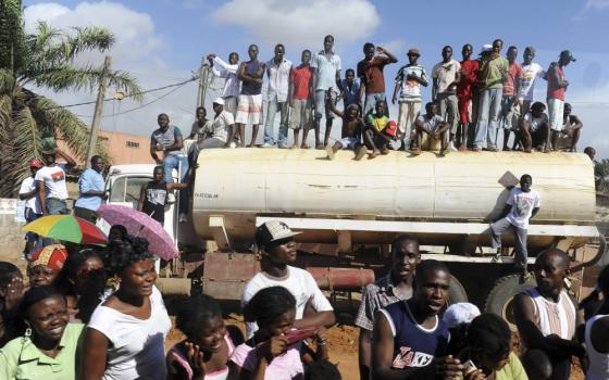 People wait for Pope Benedict XVI to pass outside St. Antonio Church in Luanda, Angola, March 22, 2009. Pope Leo XIV is expected to visit the African country, although no date has been set. (CNS/Reuters/Alessandro Bianchi)