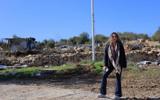 Alice Kisiya stands on her family farm in Palestine in December 2025 after the Israeli Supreme Court returned the family's land. The Kisiyas are among a minority of Christians who have lived in the Al-Makhrour valley for thousands of years and make up about 1% of the West Bank's population. (Courtesy of Alice Kisiya)