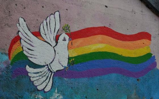 painting of rainbow and peace dove