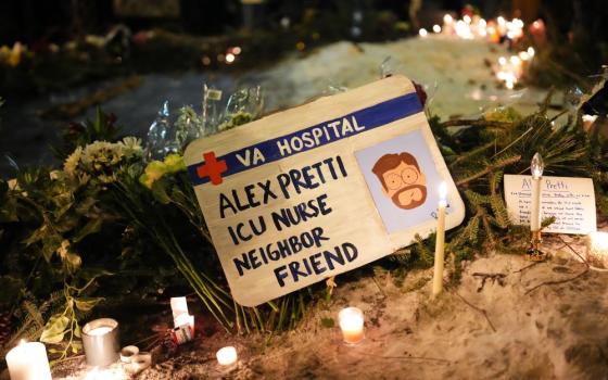A sign for 37-year-old Alex Pretti, who was fatally shot by a U.S. Border Patrol officer earlier in the day, is displayed during a vigil Jan. 24 in Minneapolis. (AP/Adam Gray)