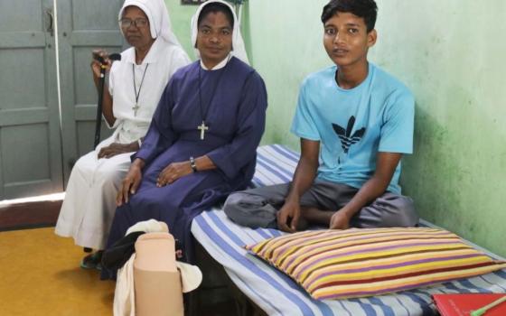 Maria Bambina Srs. Agustina Tudu, 69 (left), and Flora Rozario, 45, care for Mohammad Sowrav, a patient in the sisters' tuberculosis shelter in the Diocese of Rajshahi. (Stephan Uttom Rozario)