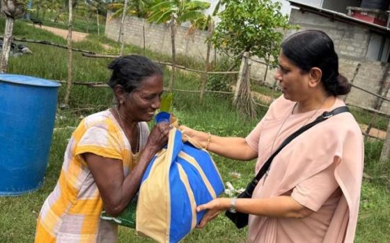 Apostolic Carmel Sr. Maria Nirmalini of India, the congregation's superior general, visits a person affected by Cyclone Ditwah in Sri Lanka. (Courtesy of Maria Ajantha)