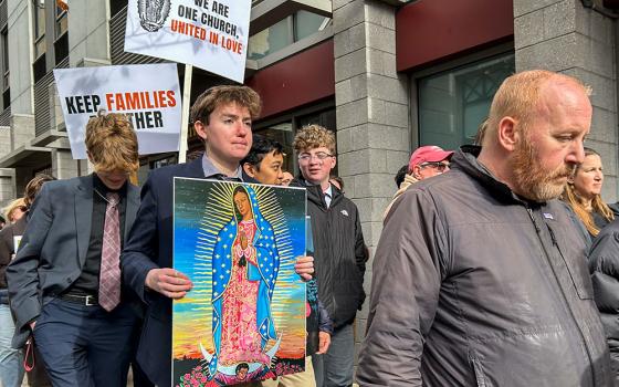 A student holds an image of Our Lady of Guadalupe during a Nov. 13, 2025, prayer vigil and eucharistic procession for immigrants outside of the Immigration and Customs Enforcement Office in Philadelphia. The vigil was one of several held across the nation that day as part of the "One Church, One Family" initiative, a grassroots effort launched by several Catholic entities. (OSV News/Gina Christian)