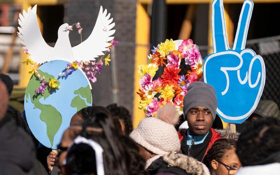 Participants hold peace signs as they gather before the District of Columbia's annual Martin Luther King Day parade Jan. 19, 2026, in Washington. (AP/Mark Schiefelbein)