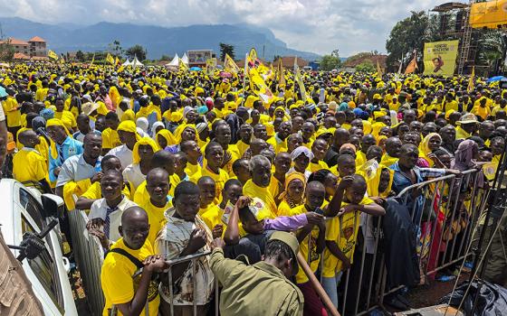 Supporters of National Resistance Movement presidential candidate Yoweri Kaguta Museveni gather at a campaign rally in Mbale City, eastern Uganda, on Nov. 10, 2025, wearing yellow party colors and waving flags as they await his address. (Gerald Matembu)
