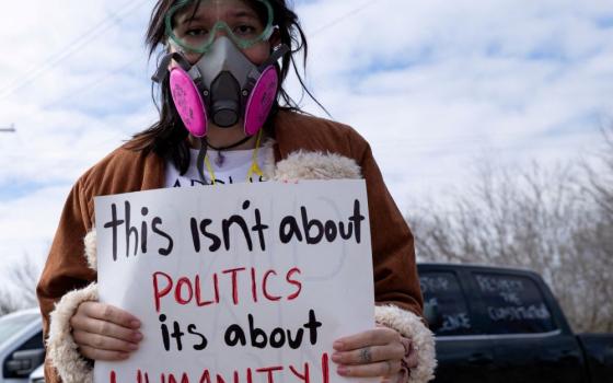 Elizabeth Anne Jolly holds a sign as she protests hours after 5-year-old Liam Conejo Ramos and his father, Adrian Conejo Arias, returned home after a judge ordered them to be released from Immigration and Customs Enforcement detention at the South Texas Family Residential Center in Dilley, Texas, Feb. 1. (OSV News/Reuters/Kaylee Greenlee)