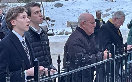 Bishop Kevin Rhoades of Fort Wayne-South Bend, Ind., third from left, prays the rosary with students at the University of Notre Dame at the Grotto of Our Lady of Lourdes Feb. 24, two weeks after calling on the university of Notre Dame to withdraw its appointment of Susan Ostermann as director of the school's Liu Institute for Asia and Asian Studies. (OSV News/Gretchen Crowe)