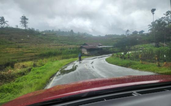 From inside a car, Indonesia's rainy season is evident on the road on the island of Flores. (GSR photo/Chris Herlinger)