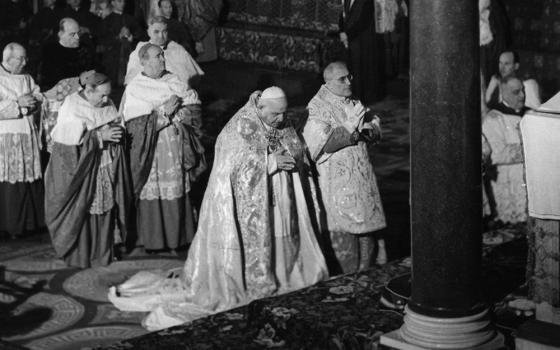 Pope John XXIII prays in the Basilica of St. Paul Outside the Walls Jan. 25, 1959, just before announcing his plans to convoke the Second Vatican Council. The pope cited a need to update the church and promote Christian unity. (CNS file photo)