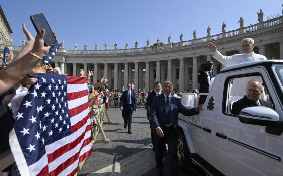 Pope Leo XIV waved to pilgrims holding a flag of the United States as he arrives in St. Peter's Square on the popemobile for his general audience at the Vatican June 18, 2025. (CNS photo/Vatican Media)