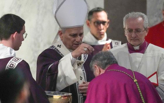 Pope Leo XIV sprinkles ashes during Ash Wednesday Mass at the Basilica of Santa Sabina in Rome Feb. 18, 2026. (CNS/Lola Gomez)