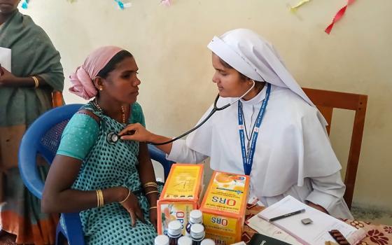 Sr. Jean Rose, a member of the Sisters of the Destitute and a medical doctor, treats a tribal woman at the government Community Health Centre in Marayoor, a remote village in the Idukki district of Kerala, southwestern India. (Courtesy of Jean Rose)