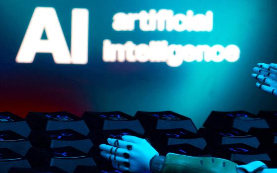 A message reading "AI artificial intelligence," a keyboard and robot hands are seen in this illustration created on Jan. 27, 2025. (OSV News/Reuters/Dado Ruvic)