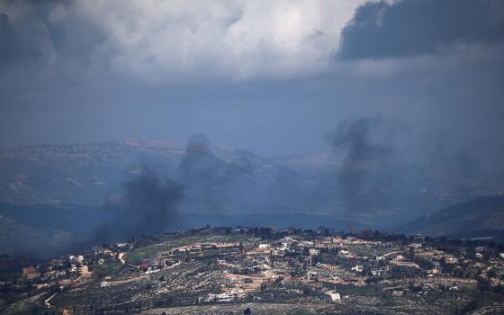 Smoke rises from a village in Lebanon as seen from northern Israel, March 16, 2026, following an Israeli airstrike, amid escalation in aerial attacks between Hezbollah and Israel as the U.S.-Israeli war with Iran continues. (OSV News/Reuters/Shir Torem)