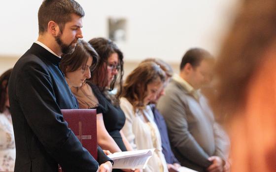 Fr. Christopher Masla holds the Book of the Elect at the Diocese of Richmond's Rite of Election at Our Lady of Nazareth Church in Roanoke, Va., March 1, 2026. In a record for the Diocese of Richmond, 900 people will be baptized, receive the Eucharist, and be confirmed in the Catholic Church at Easter Vigil Masses April 4. (OSV News/Diocese of Richmond/Ryan Hunt)