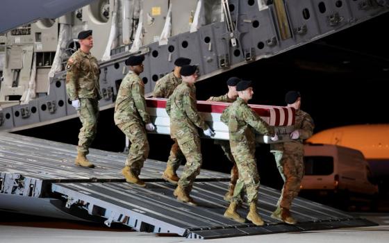 Members of the military carry a transfer case during the dignified transfer of the remains of U.S. Army Sgt. Benjamin Pennington at Dover Air Force Base in Delaware March 9. Pennington died on March 8 from injuries sustained during a March 1 attack at Prince Sultan Air Base in Saudi Arabia. The U.S. military says 13 U.S. service members have died in the U.S.-Israeli war with Iran. (OSV News/Kylie Cooper)