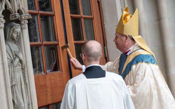 Bishop John Bonnici knocks on the door of the cathedral ahead of his installation Mass as the 10th bishop of Rochester, N.Y., at Sacred Heart Cathedral in Rochester March 19, 2026. He was previously an auxiliary bishop in New York. (OSV News/Jeff Witherow, Catholic Courier)