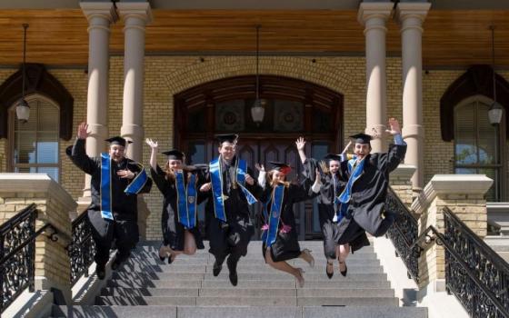 Graduates celebrate on the steps of the main building at the University of Notre Dame following their May 15, 2016, commencement ceremony in Indiana. (CNS/University of Notre Dame/Barbara Johnston)