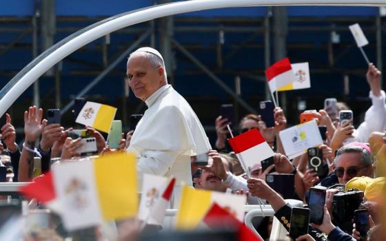 Pope Leo XIV smiles as he arrives at the church of St. Devota for a meeting with young people and catechumens, as part of a one-day trip in Monaco, March 28. It is Leo's first international journey of 2026 and only the second of his pontificate. (OSV News/Reuters/Guglielmo Mangiapane)