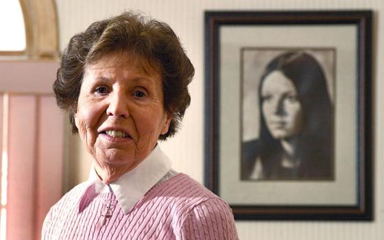 Julia Quinlan stands next to a photo of daughter Karen Ann at the Center of Hope Karen Ann Quinlan Hospice Feb. 24, 2005, in Newton, N.J. In October 1975, Julia and her husband, Joe, sought a court order to have Karen's respirator turned off so she could die naturally. On Nov. 10 of that year, the judge denied the request. The Quinlans appealed and won a reversal on March 31, 1976, and their daughter was weaned off the respirator. She died June 11, 1985. (CNS/The Beacon/Joe Gigli)