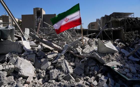 An Iranian flag is placed among the ruins of a police station struck March 2 during the U.S.-Israeli military campaign in Tehran, Iran, March 3. (AP/Vahid Salemi)