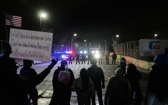 Federal immigration officers confront protesters outside Bishop Henry Whipple Federal Building in Minneapolis, on Jan. 15, 2026. (AP Photo/Yuki Iwamura, File)