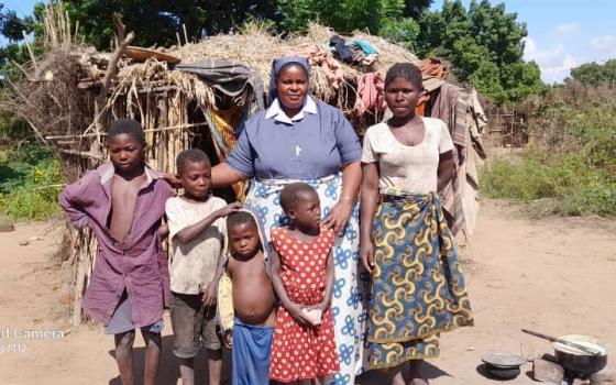 Fatima Katandika (right) and her four young children were driven from home by her husband. Mary Consoler of the Afflicted Sisters in Malawi assisted her to build a makeshift shelter and to start an income-generating project. (Courtesy of Mary Consoler of the Afflicted Sisters)