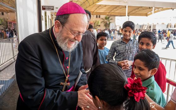 Bishop Paolo Martinelli, apostolic vicar of Southern Arabia, greets children during a pastoral visit in February 2026. (Courtesy of Apostolic Vicariate of Southern Arabia)