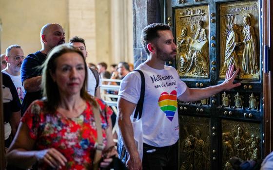 Some of the hundreds of LGBTQ+ Catholics and their families who joined a Holy Year pilgrimage to Rome walk through the Holy Door of St. Peter's Basilica at the Vatican Sept. 6, 2025. (AP/Andrew Medichini)