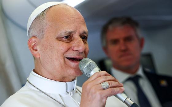 Pope Leo XIV speaks to members of the media aboard the papal plane April 15, 2026, en route to Yaoundé, Cameroon, amid his apostolic journey. (OSV News/Guglielmo Mangiapane, pool)
