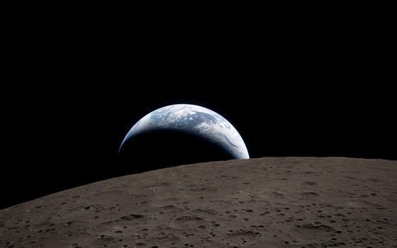 A view of Earth, partially hidden by the moon, is photographed through the Orion spacecraft window on April 6, 2026, during the Artemis II crew's flyby of the moon. (OSV News/NASA handout via Reuters)