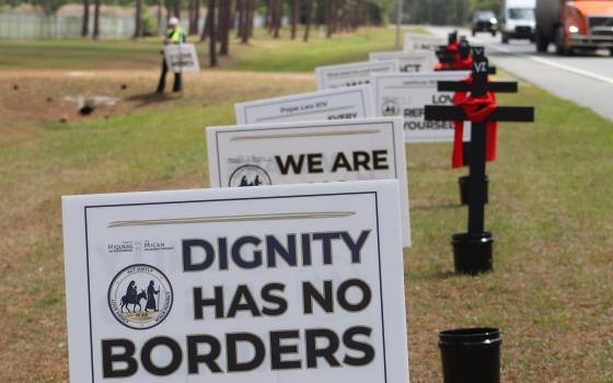 For a reflection on the Stations of the Cross reflection April 3, 2026, crosses mark each of the 14 stations on the side of Highway 90 in north Florida. More than four dozen advocates participated in the reflection an then walked across the street from Deportation Depot, the former Baker Correctional Institution used to house immigrant detainees. 