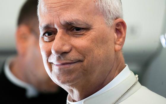 Pope Leo XIV takes a moment to speak with journalists aboard the papal flight from Angola to Equatorial Guinea April 21, 2026. Leo paused to honor his predecessor on the first anniversary of Pope Francis' death, remembering the Argentine pope's witness to mercy and closeness to the poor. (CNS/Lola Gomez)