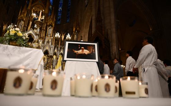 Lit candles lie in front of a portrait of Pope Francis at the Basilica of Lujan in Argentina April 21, 2026, in honor of the pontiff on the first anniversary of his death. Pope Francis, formerly Argentine Cardinal Jorge Mario Bergoglio, died April 21, 2025, at age 88. 