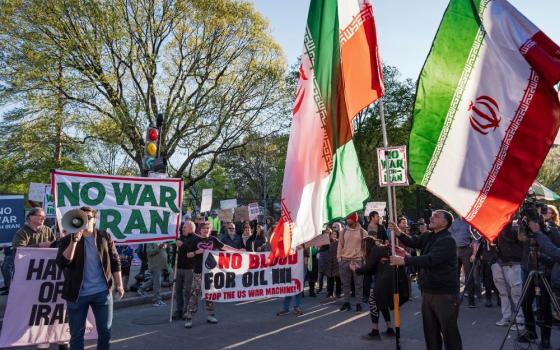 Activists protest near the White House in Washington April 7. Earlier in the day President Donald Trump had doubled down on threats to annihilate Iran. (AP/J. Scott Applewhite)