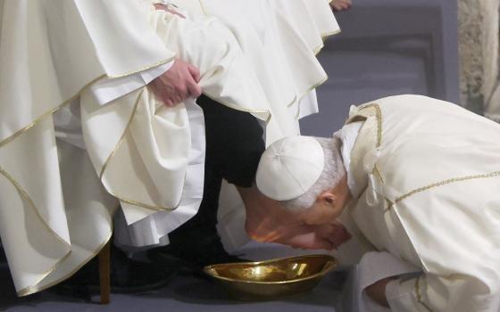 Pope Leo XIV kisses the foot of a clergyman after washing it as he celebrates the Holy Thursday Mass of the Lord's Supper in the Basilica of St. John Lateran at Vatican April 2, 2026. (OSV News/Reuters/Vincenzo Livieri)