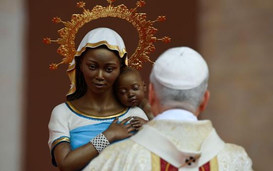 Pope Leo XIV prays in front of a statue of Mary and the Christ Child as he celebrates the final Mass of his apostolic journey to Africa at Malabo Stadium in Equatorial Guinea April 23, 2026. (OSV News/Vatican Media/Matteo Pernaselci)