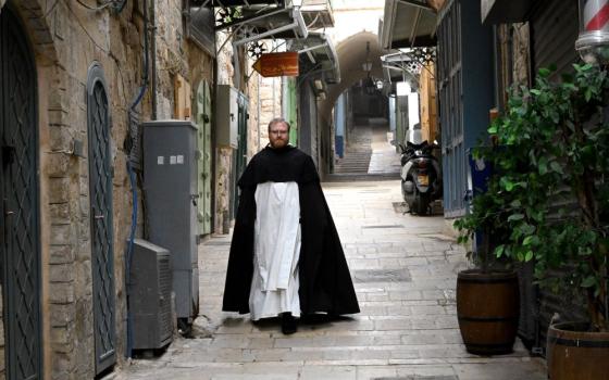 A priest walks on the Via Dolorosa on Good Friday, in the Old City of Jerusalem, April 3, 2026. Israeli security forces stopped Christians from reaching the Via Dolorosa, while allowing Muslims and Jews passage to the area. Border police said the safety precautions were because of the U.S.-Israeli war with Iran. (OSV News/Debbie Hill)