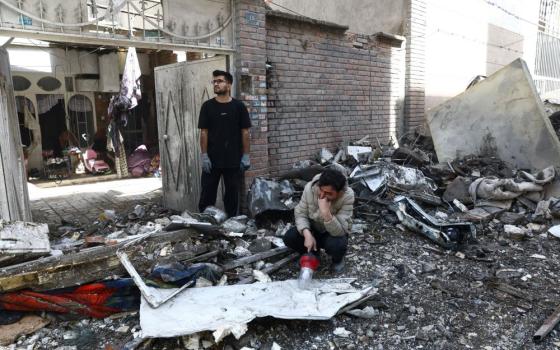 People react at the site of a residential building in Tehran, Iran, March 27, that was damaged by a strike amid the U.S.-Israeli war with Iran. (OSV News/Reuters/West Asia News Agency/Majid Asgaripour)