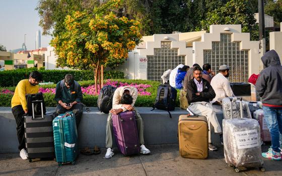 Passengers stranded by the closure of Dubai International Airport await assistance in the airport parking lot in Dubai, United Arab Emirates, March 1, 2026. (AP/Altaf Qadri)