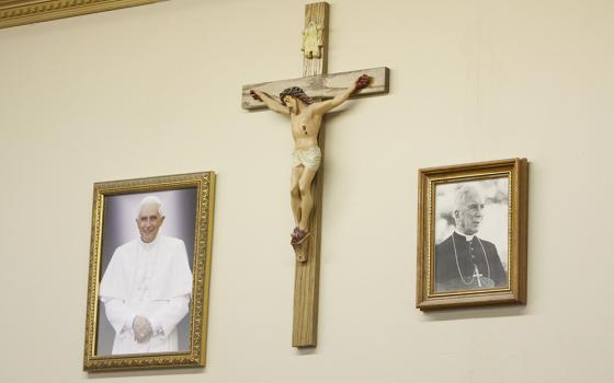Portraits of Pope Benedict XVI and Archbishop Marcel Lefebvre, founder of the Society of St. Pius X, flank a crucifix in the community room at St. Michael the Archangel Chapel in Farmingville, New York, Feb. 1, 2009. (CNS/Gregory A. Shemitz)