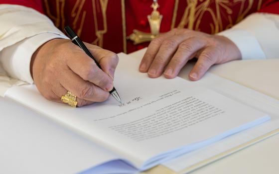 Pope Leo XIV signs Magnifica Humanitas at the Vatican's Synod Hall May 15, 2026. (OSV News/Vatican Media/Simone Risoluti)