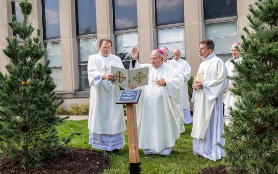 St. Paul-Minneapolis Archbishop Bernard Hebda blesses two trees and a plaque outside the Archdiocesan Catholic Center in St. Paul Aug. 27, 2026, in memory of Harper Moyski and Fletcher Merkel, who died during a shooting at Annunciation Church in Minneapolis Aug. 27, 2025. (OSV News/Catholic Spirit/Dave Hrbacek)