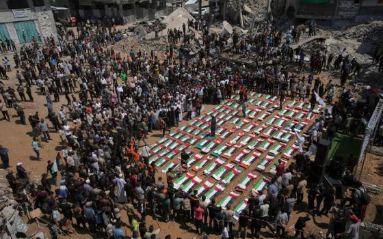 Bodies of members of the Hassayna and Abu Sharia families, killed in an Israeli strike in 2023 and recently recovered from the rubble, are draped in Palestinian flags during their funeral in Gaza City, Tuesday, Aug. 4, 2026. (AP/Jehad Alshrafi)