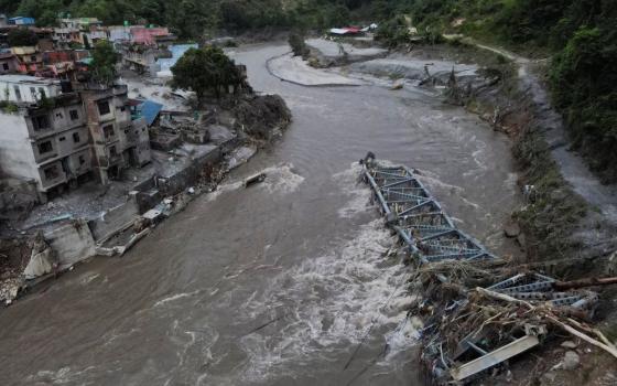 A drone view shows a broken bridge and damaged houses after the flash floods and mudslide, at Devighat, Nuwakot district, Nepal, Aug. 28, 2026. (OSV News/Reuters/Francis Mascarenhas)