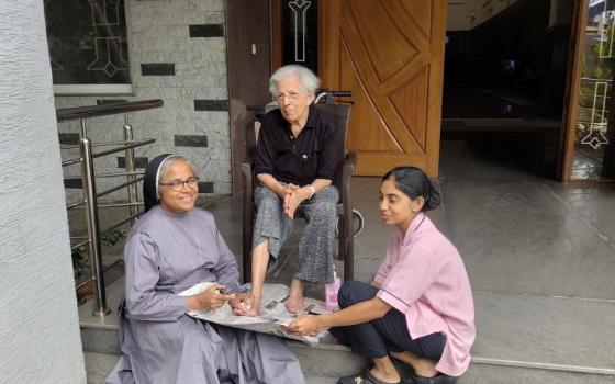 Sr. Suchita Kavumkal, a staff member at Elizabeth Care Home in Bengaluru, southern India, managed by the Augustinian Sisters, helps care for Jessie Pai, an 88-year-old resident. (George Kommattam)