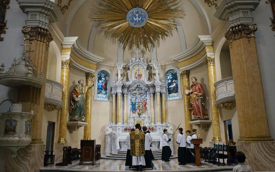 Fr. John Ubel, pastor of the Church of Saint Agnes, processes into the sanctuary with altar servers at the start of one of the Catholic parish’s Latin Masses in St. Paul, Minn., June 28, 2026. (AP Photo/Giovanna Dell’Orto)